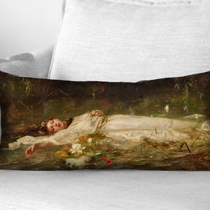 May include: A painting of a woman lying in a body of water. She is wearing a white dress and has long, dark hair. The water is murky and there are lily pads and other plants growing in it.
