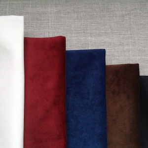 May include: Five fabric swatches, one white, one red, one blue, one brown, and one black.