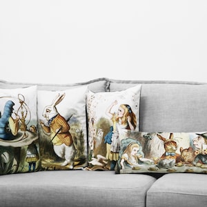 May include: Four decorative throw pillows with illustrations from Alice in Wonderland. The pillows feature a caterpillar smoking a hookah, a white rabbit holding a pocket watch, Alice falling down a rabbit hole, and the Mad Hatter, March Hare, and Dormouse having tea.
