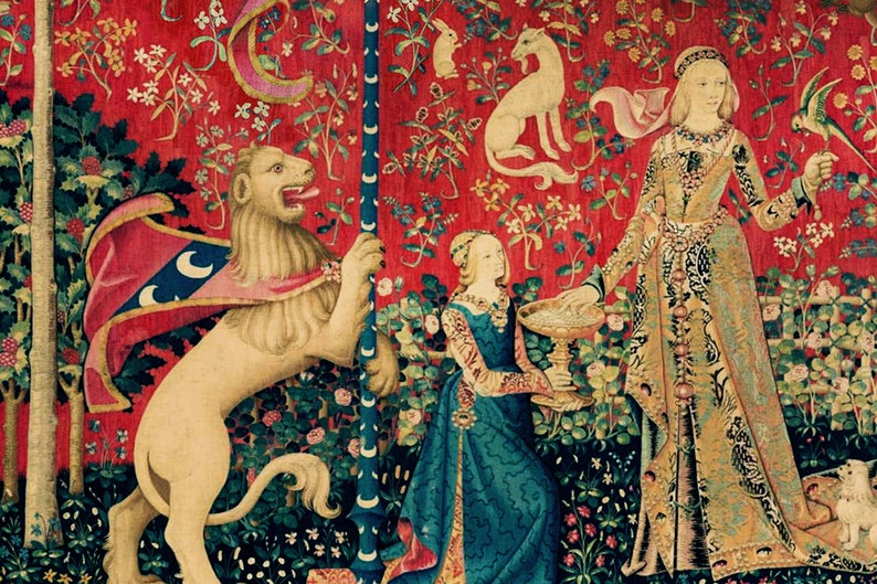 May include: A tapestry depicting a scene from the Lady and the Unicorn series. A white lion stands on its hind legs, holding a staff with a crescent moon design. A woman in a blue dress holds a chalice, while another woman in a gold dress stands behind her. The tapestry is filled with intricate details, including flowers, leaves, and other animals.