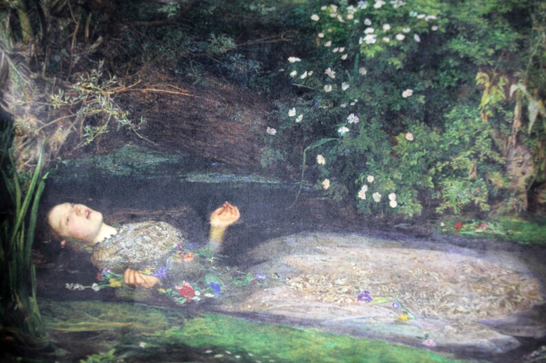 May include: A painting depicting a woman lying in a stream of water. She is wearing a white dress and has flowers in her hair. The water is clear and the sky is blue.