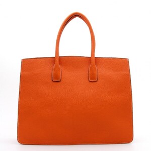 May include: A bright orange tote bag with a textured surface, featuring two matching top handles attached to the main body. The bag has a rectangular shape with clean, straight edges and visible stitching along the perimeter and handle bases.