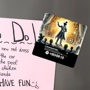 May include: A black and white illustration of a man in a top hat performing on stage. The image is a Spotify code for the song "A Sentimental Man" from the musical "Wicked".