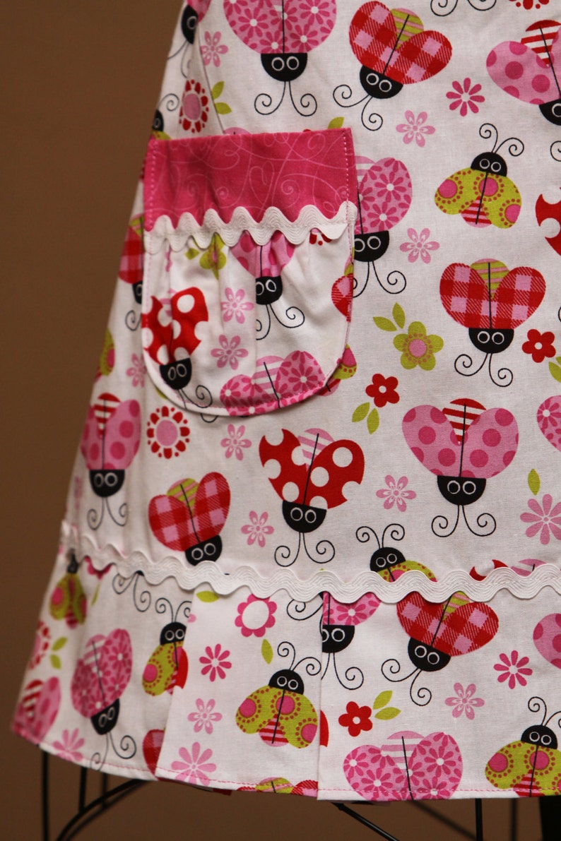 Colorful Ladybugs with Pink Trim on White Background Childrens Apron