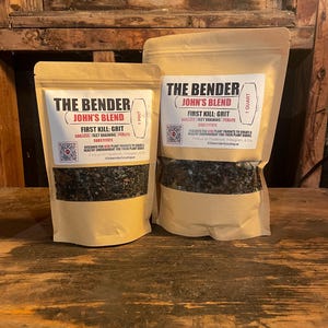May include: Two tan stand-up pouches containing dark soil mix labeled The Bender John's Blend First Kill: Grit. The smaller pouch is marked 1 Pint and the larger pouch is marked 1 Quart. Both feature a QR code and text about soilless fast draining perlite substitute.