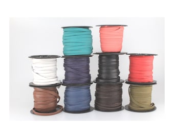 May include: Ten spools of leather cord in various colors, including white, teal, red, brown, and olive green. The spools are arranged in three rows.