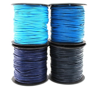 May include: Four spools of leather cord in shades of blue and navy. The cords are tightly wound on black spools, with the colors ranging from light turquoise to deep navy. The image is set against a plain white background.