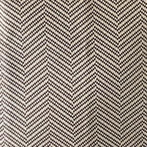May include: A close-up of a brown and white herringbone fabric. The fabric has a subtle texture and a repeating pattern.