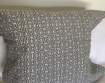 May include: A black and white geometric patterned pillow with a square design.