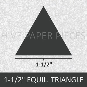 May include: A black 1-1/2 inch equilateral triangle paper piece on a white background with a floral pattern.  Hive Paper Pieces.