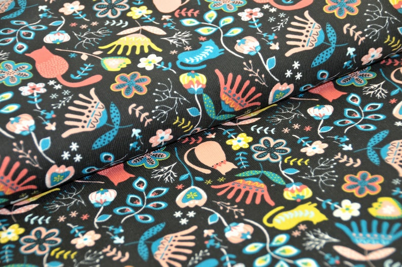 May include: Black fabric with a repeating pattern of stylized flowers, leaves, and cats in pink, blue, yellow, and red.