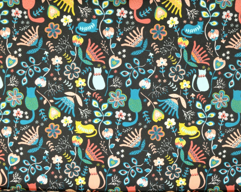 May include: A black fabric with a repeating pattern of stylized flowers, leaves, and cats. The cats are in various shades of blue, green, and pink. The flowers are in shades of pink, red, and yellow. The leaves are in shades of green and blue.