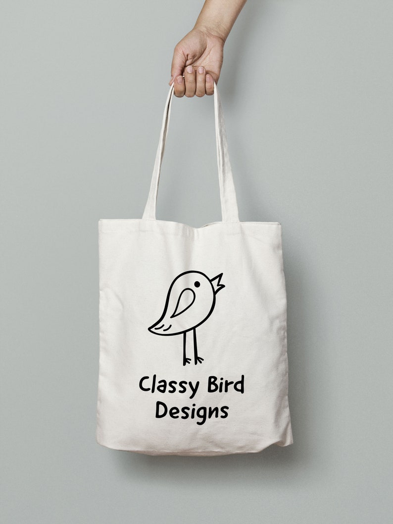 May include: White canvas tote bag with black handles and a black and white illustration of a bird with the text "Classy Bird Designs" printed on the front.