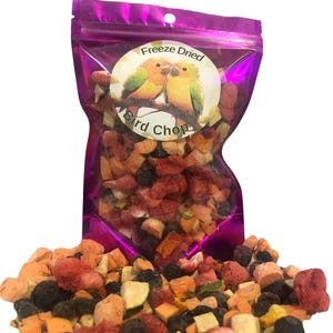 May include: A purple resealable bag filled with freeze-dried bird chop. The bag has a white label with the text "Freeze Dried Bird Chop" and a picture of two yellow and orange parakeets.