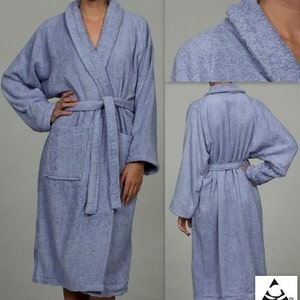 May include: A light blue bathrobe with a shawl collar and a tie belt. The robe is made of soft, absorbent terry cloth.  The robe has a patch pocket on the left side.  The text "Egyptian Cotton" is printed on the bottom right corner of the image.