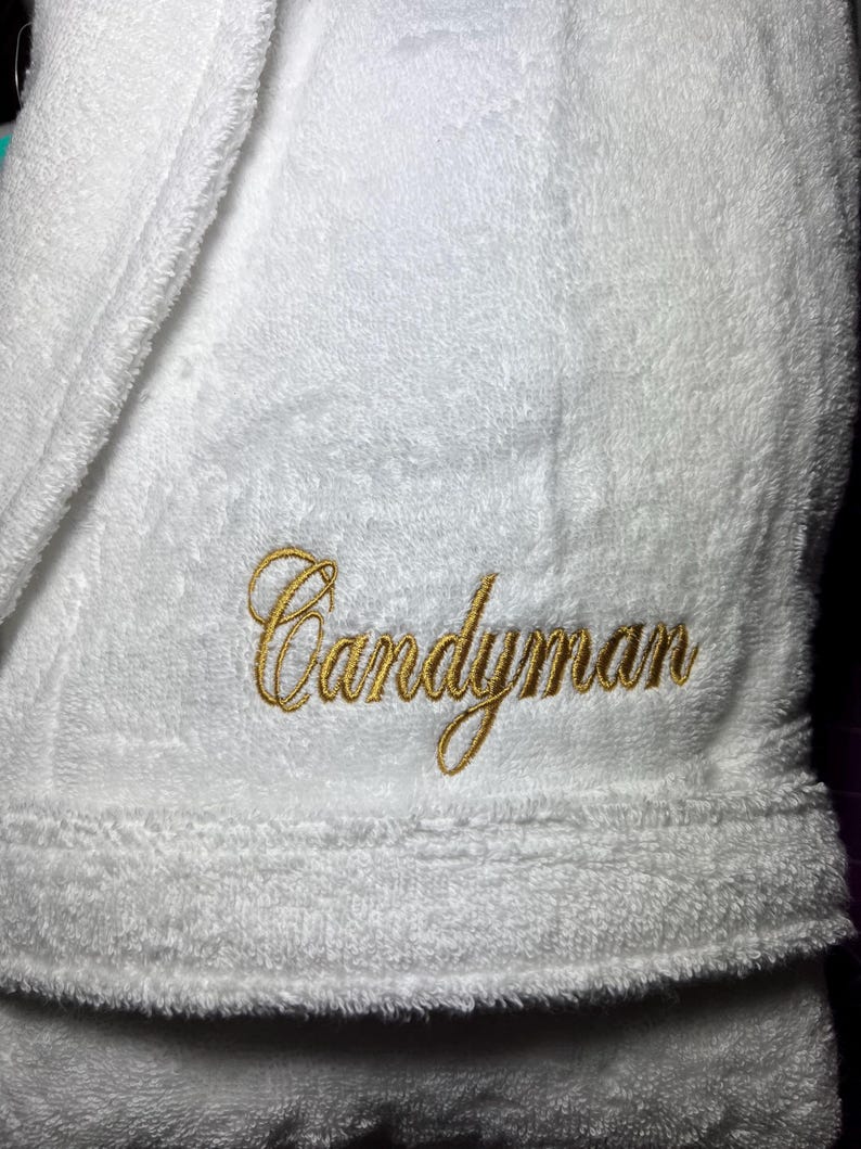 May include: White bathrobe with the name "Candyman" embroidered in gold thread.