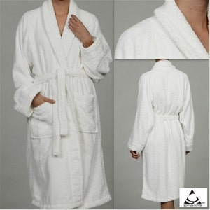 May include: White bathrobe with a shawl collar, long sleeves, and a tie belt. The robe has two pockets on the front and is made of soft, absorbent terry cloth.