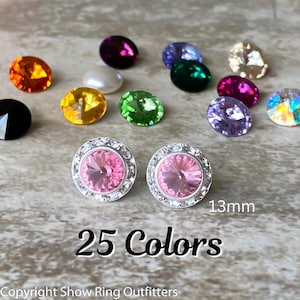 May include: A pair of silver earrings with pink crystal stones surrounded by a halo of smaller clear stones. The earrings are 13mm in diameter. The text "25 Colors" is written below the earrings.