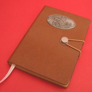 Alice&#39;s Adventures in Wonderland Hand Cast Pewter Motif Plaque on A6 Tan Notebook - &#39;Alice Drink Me&#39; - Alice in Wonderland Gift