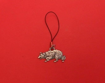 May include: A silver charm of a border collie dog on a black string.