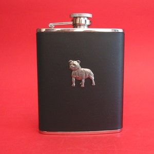 May include: Black stainless steel hip flask with a silver Staffordshire Bull Terrier design.