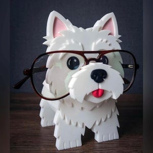 May include: White ceramic figurine of a dog wearing glasses. The dog has a pink nose and tongue. The glasses are brown with black frames.