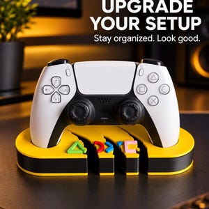 May include: A white and black wireless game controller resting on a yellow and black oval stand featuring three small, colorful geometric icons. The text UPGRADE YOUR SETUP and Stay organized. Look good. is printed in white above the controller.