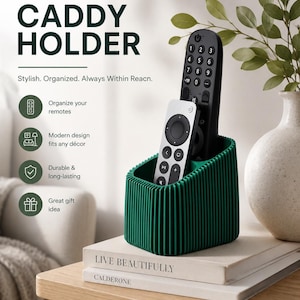 May include: A dark green remote caddy holder with a vertical ribbed texture, containing one black television remote and one silver streaming device remote. The text "Modern Remote CADDY HOLDER" and "Stylish. Organized. Always Within Reacn." is visible.