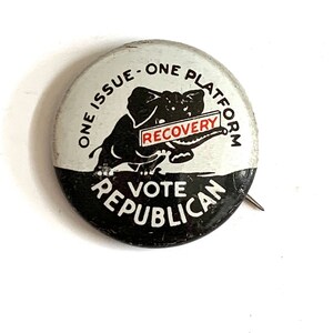 May include: A vintage political badge with a black and white design. The badge features a black elephant holding a sign that reads "RECOVERY." The text around the elephant reads "ONE ISSUE - ONE PLATFORM" and "VOTE REPUBLICAN."