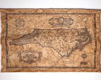 May include: A vintage-style map of North Carolina, printed on parchment paper with a brown and black color scheme. The map shows the state's counties and major cities. The text "North Carolina" is printed in a decorative font at the bottom of the map. The map is surrounded by a decorative border.