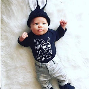 Black boy easter bodysuit adorned with a funny graphic featuring a bunny wearing sunglasses and text saying too hip to hop