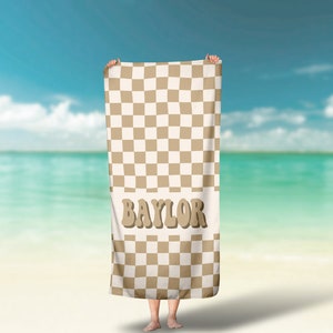 May include: A brown and white checkered beach towel with the word "BAYLOR" in brown letters.