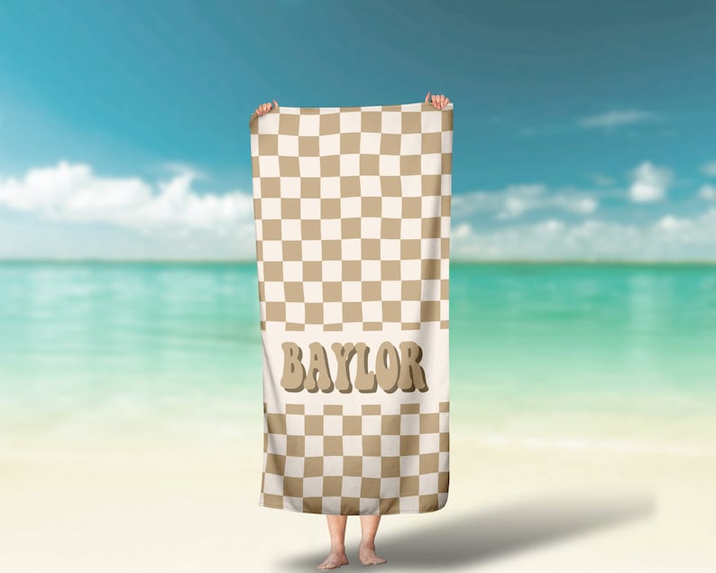 May include: A brown and white checkered beach towel with the word "BAYLOR" in brown letters.