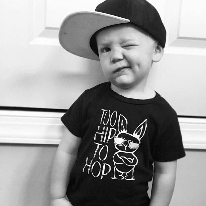 Black boy easter shirt adorned with a funny graphic featuring a bunny wearing sunglasses and text saying too hip to hop