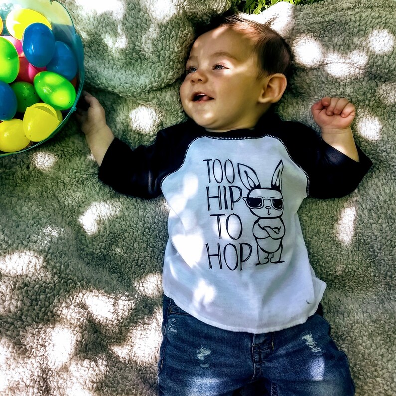 Black and white raglan boy easter shirt adorned with a funny graphic featuring a bunny wearing sunglasses and text saying too hip to hop