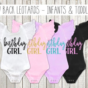 May include: Four white, pink, lavender, and black leotards with ruffled sleeves. Each leotard has the text "birthday girl" in gold glitter lettering.