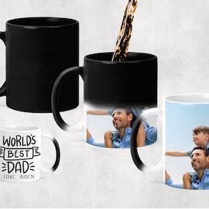 May include: A black magic mug with a white interior. The mug is blank when cold, but reveals a photo of a father and son when hot. The mug also has a white text design that reads "World's Best Dad" with the name "Aiden" underneath.