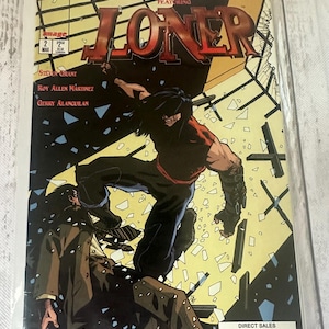 May include: Comic book cover featuring the title "LONER" with a dynamic illustration of a figure in action. The cover has a dark color scheme with the text "WILDSTORM SPOTLIGHT" and the issue number 2.
