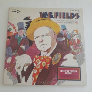 May include: A vintage record album cover featuring a cartoon illustration of W.C. Fields, a famous comedian, with a colorful background. The album title is "W.C. Fields" and the text "The Original Voice Tracks From His Greatest Movies" is also included. The album cover includes a free pop poster inside.