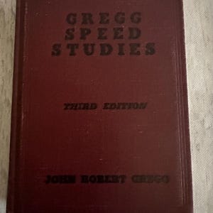 May include: A burgundy hardcover book titled "Gregg Speed Studies" with the words "Third Edition" and "John Robert Gregg" printed on the front cover.