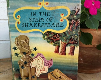 May include: A vintage book cover with a blue background and a yellow border. The title is "In the Steps of Shakespeare" with a bust of Shakespeare in the lower left corner. The author is Russell Thorndike. The book is published by Rich & Cowan.