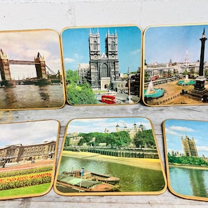 May include: Set of six coasters featuring iconic London landmarks. Each coaster is made of wood and features a different image, including Tower Bridge, Big Ben, and Trafalgar Square.