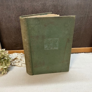 May include: A vintage green hardcover book with a white label on the front cover.
