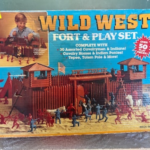 May include: A vintage "Wild West Fort & Play Set" toy box. The box features a fort with watchtowers, miniature figures of cavalrymen, Native Americans, horses, and a teepee. The box reads "Over 50 Play Pieces!" and "Made in U.S.A."