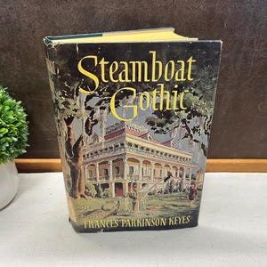 May include: A vintage copy of "Steamboat Gothic" by Frances Parkinson Keyes. The book cover features a detailed illustration of a grand house with a fountain, trees, and figures. The title is in large, gold lettering.
