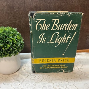 May include: A green hardcover book titled "The Burden Is Light" by Eugenia Price. The subtitle is "The Autobiography of a Transformed Pagan".