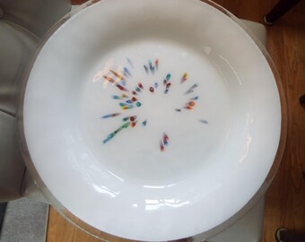 May include: White ceramic plate with a decorative design of colorful dots and lines radiating from the center.