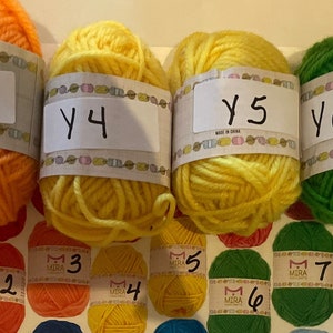 May include: Eight balls of yarn in various colors, labeled Y2, Y3, Y4, Y5, Y6, and Y8. The yarn is arranged in a row on a white surface.