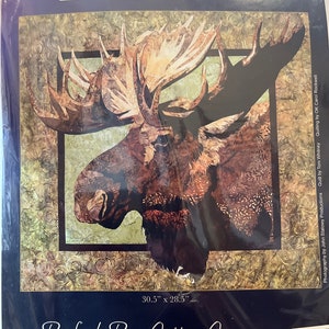 May include: A quilting pattern featuring a close-up of a moose's head with large antlers. The pattern is titled "Summer Serenity" by Toni Whitney and is a product of Bigfork Bay Cotton Company. The pattern measures 30.5 inches by 28.5 inches.