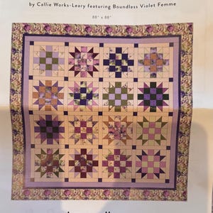 May include: A quilt kit titled "Corsage Violet Femme" by Callie Works-Leary. The quilt features a repeating star pattern in shades of purple, green, and peach. The quilt measures 88 x 88 inches.